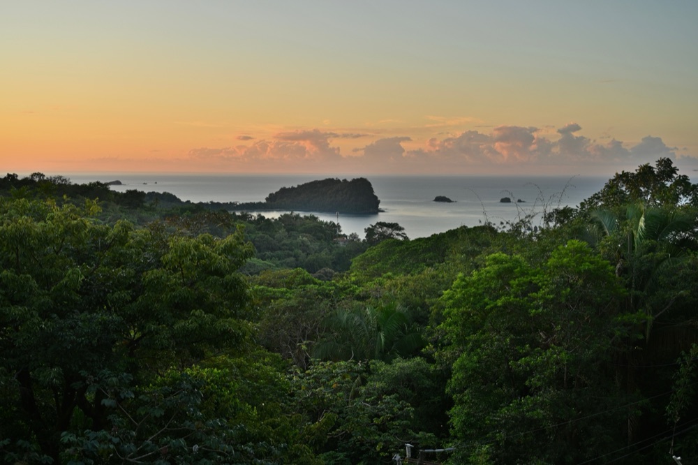 Sunset over a rainforest coastline and the ocean